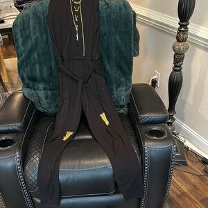 Michael Kors M Elegant Black Jumpsuit with gold chain details.